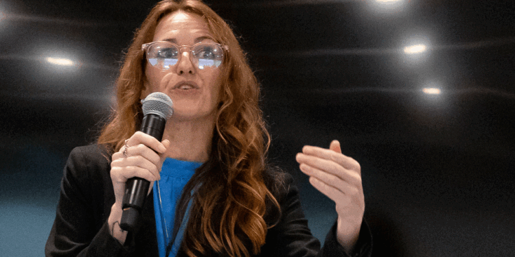 Maureen Galindo speaks at an event with Johnny Garcia.