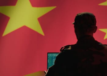 A Chinese engineer works on a computer.