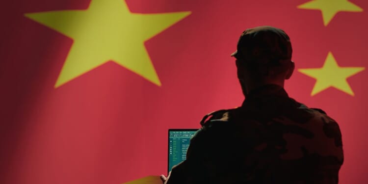 A Chinese engineer works on a computer.