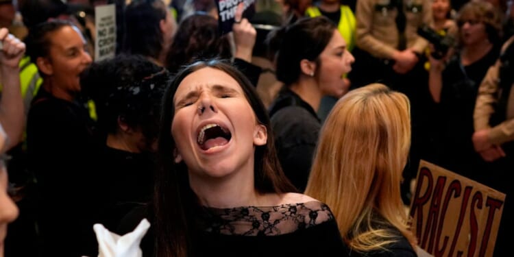 A woman protests outside the House chamber before a special session of the state legislature to redraw U.S. Congressional voting maps Thursday in Nashville, Tennessee.