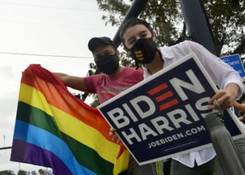Supporters of now-former President Joe Biden and Vice President Kamala Harris gather in the street as they celebrate on Nov. 7, 2020, in Wilton Manors, Florida.