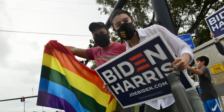 Supporters of now-former President Joe Biden and Vice President Kamala Harris gather in the street as they celebrate on Nov. 7, 2020, in Wilton Manors, Florida.
