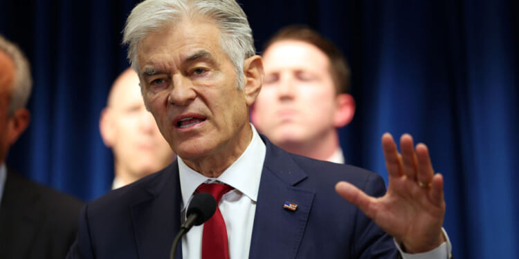 Dr. Mehmet Oz gestures as he speaks to media at a press conference.