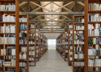 A library interior with books on wooden bookshelves.