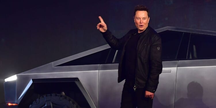 Tesla CEO Elon Musk gestures while introducing the newly unveiled all-electric battery-powered Tesla Cybertruck at Tesla Design Center in Hawthorne, California, on Nov. 21, 2019.