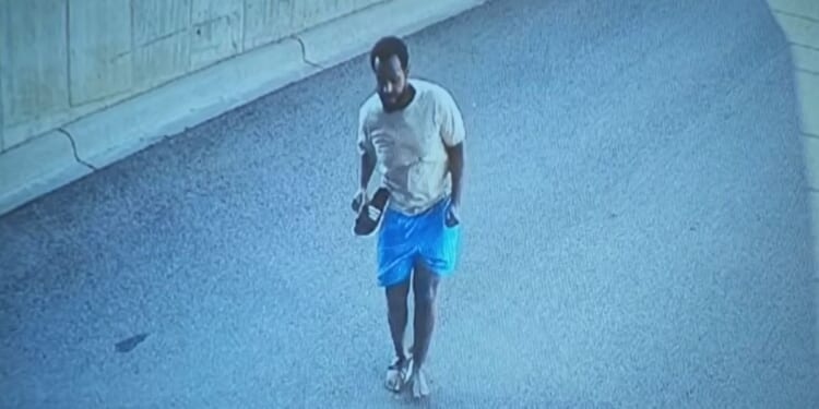 The suspect in a Minnesota fraud investigation is seen on surveillance video fleeing down a ramp.
