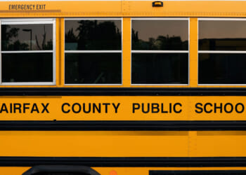 Side of a yellow Fairfax County Public Schools bus.