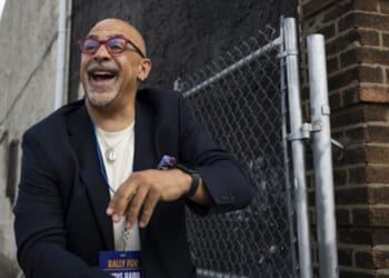 Pennsylvania State Representative Chris Rabb leans over a fence during a campaign event on May 15, 2026.