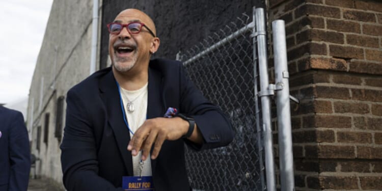 Pennsylvania State Representative Chris Rabb leans over a fence during a campaign event on May 15, 2026.
