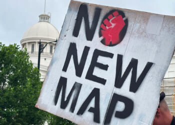 A demonstrator holds up a sign outside the Alabama Statehouse in Montgomery, Alabama, on May 7, 2026.