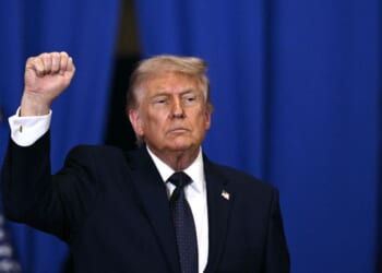 President Donald Trump raises a fist as he departs after delivering a speech about the economy at Rockland Community College Fieldhouse in Suffern, New York, on May 22, 2026.