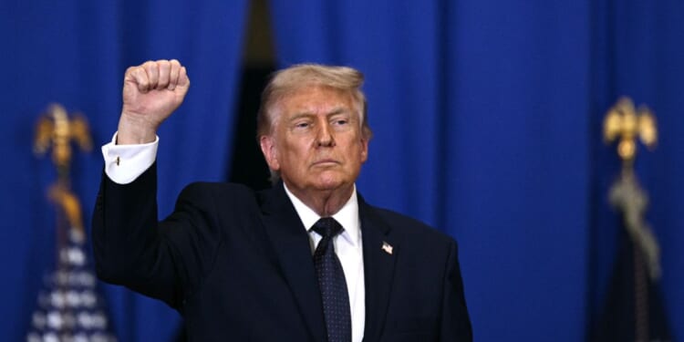 President Donald Trump raises a fist as he departs after delivering a speech about the economy at Rockland Community College Fieldhouse in Suffern, New York, on May 22, 2026.