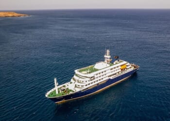 This aerial picture shows a general view of the cruise ship MV Hondius stationary off the port of Praia, the capital of Cape Verde, on May 3, 2026.