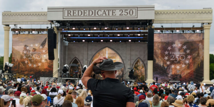 Attendees celebrate during "Rededicate 250: A National Jubilee of Prayer, Praise and Thanksgiving" on the National Mall in Washington, DC, on May 17, 2026.