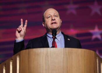 Colorado Governor Jared Polis speaks on stage at the Democratic National Convention in Chicago on Aug. 21, 2024.