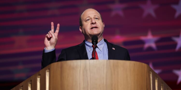 Colorado Governor Jared Polis speaks on stage at the Democratic National Convention in Chicago on Aug. 21, 2024.