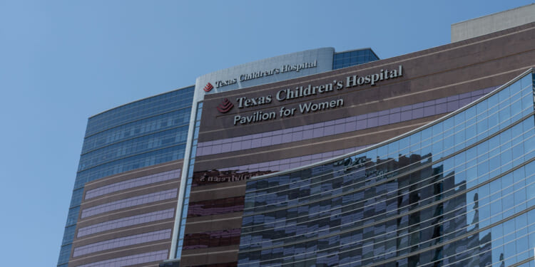 Low-angle shot of Texas Children's Hospital against a blue sky.