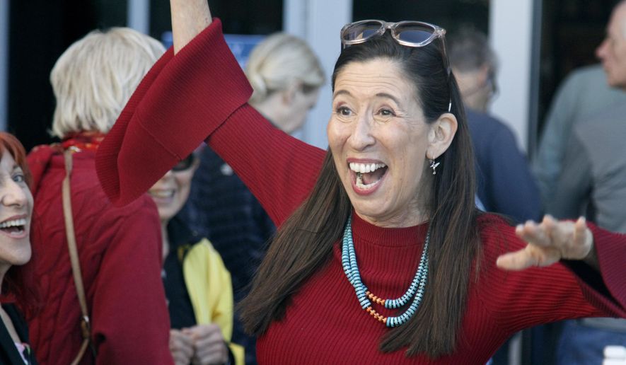 Democratic U.S. Rep. Teresa Leger Fernandez greets friends as she waits in line to cast a ballot on the first day of general election voting Tuesday, Oct. 11, 2022, outside the Santa Fe County clerk's office in Santa Fe, N.M.  (AP Photo/Morgan Lee)