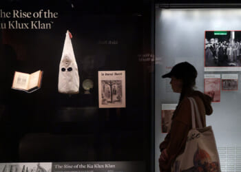 A visitor browses an exhibition about the rising of the Ku Klux Klan.
