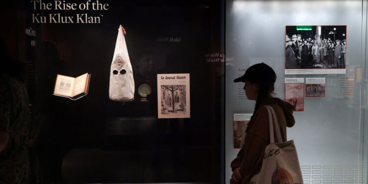 A visitor browses an exhibition about the rising of the Ku Klux Klan.