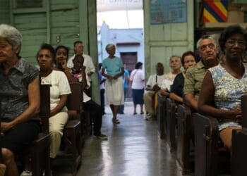 Parishioners sit and listen during a Catholic Church service in a poor suburb in Santiago de Cuba, Cuba on March 24, 2012.