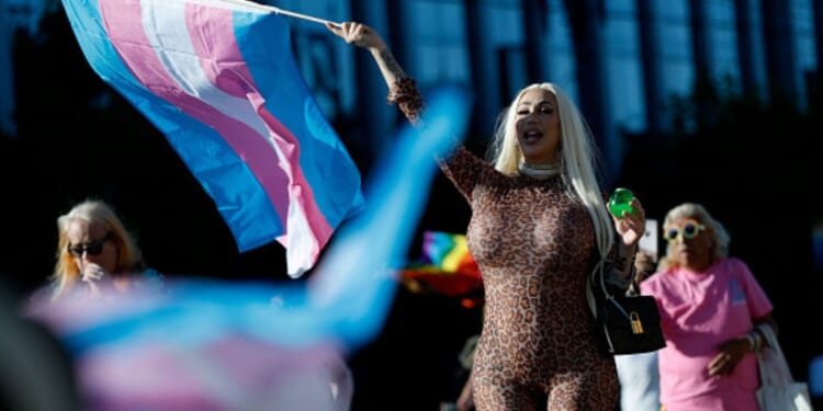 The transgender flag waves as a participant of the 21st San Francisco Annual Trans March holds it while screaming on June 27, 2025.