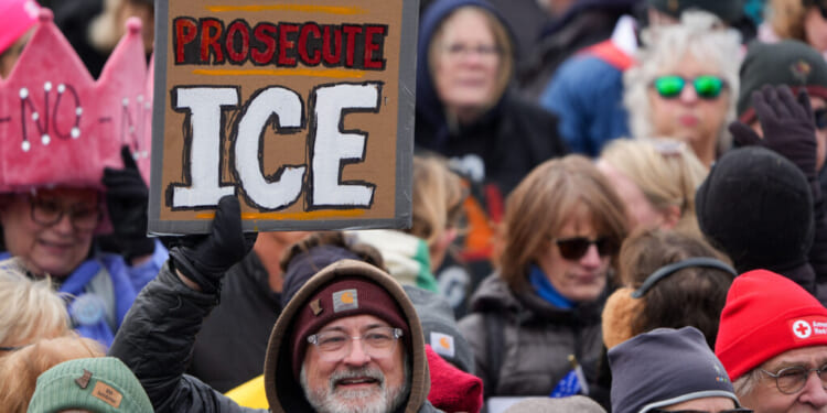 A protester holds a sign reading "Prosecute ICE" during a "No Kings" rally at the Minnesota State Capitol in St. Paul on Saturday, March 28, 2026. (Jerry Holt/The Minnesota Star Tribune/Getty Images)