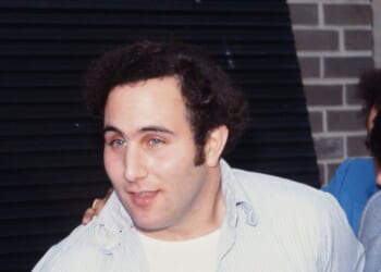 Police officers escort accused and ultimately convicted serial killer David Berkowitz, known as the Son of Sam, into the 84th precinct station in New York on Aug. 10, 1977.