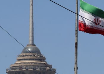 The Iranian flag flutters near the Milad Tower, part of the International Trade and Convention Center of Tehran, in the capital on May 25, 2026.