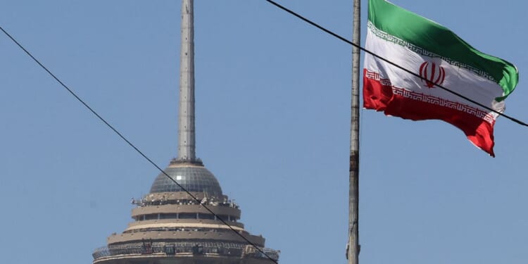 The Iranian flag flutters near the Milad Tower, part of the International Trade and Convention Center of Tehran, in the capital on May 25, 2026.