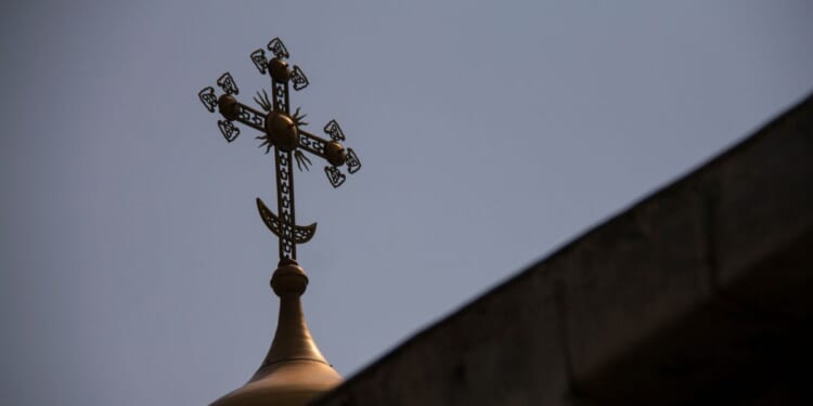 A cross sits on top of the Dulab Mausoleum in Tehran.