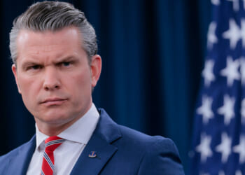 Close-up of Secretary of War Pete Hegseth as he speaks to reporters.