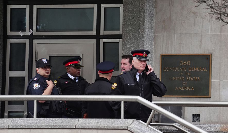 FILE - Toronto police officers investigate outside the U.S. consulate in Toronto on March 10, 2026. (Frank Gunn/The Canadian Press via AP, File)
