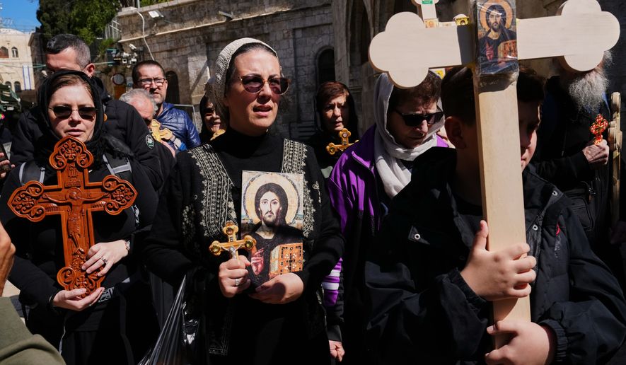 Orthodox Christian pilgrims carry crosses during Good Friday procession in the Old City of Jerusalem on Friday, April 10, 2026. (AP Photo/Mahmoud Illean)