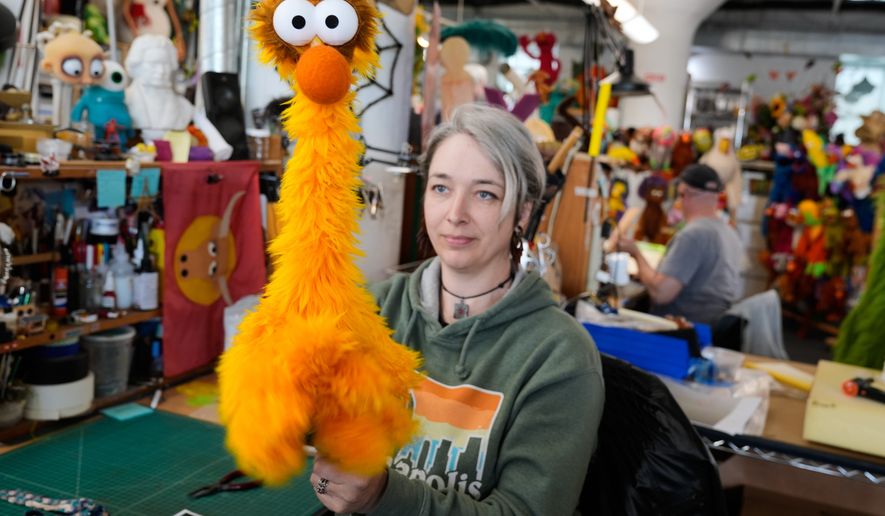 Sierra Schoening, a senior puppet builder, demonstrates how to maneuver a puppet she built at Jim Henson's Creature Shop in New York, Wednesday, May 13, 2026. (AP Photo/Seth Wenig)