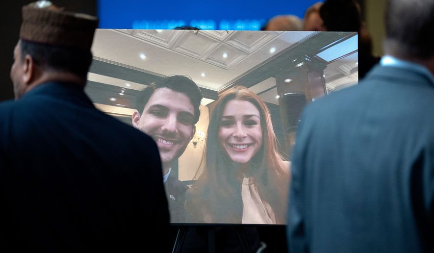 Visitors walk past a photo of slain Israeli Embassy staff members Yaron Lischinsky, left, and Sarah Milgrim, right, before a service to mark the reopening of the Capital Jewish Museum after the two were killed following an event at the museum, May 29, 2025, in Washington. (AP Photo/Mark Schiefelbein, File)