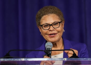 Los Angeles Mayor Karen Bass speaks into a microphone.