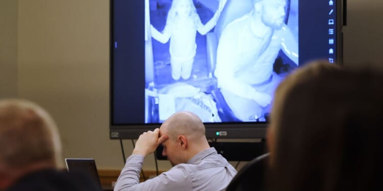 Defendant Tanner Horner reacts April 7 during testimony at the Tim Curry Criminal Justice Center in Fort Worth, Texas. Horner pleaded guilty to capital murder in the November 2022 strangulation killing of 7-year-old Athena Strand. The child is pictured in the video on the screen in the courtroom as Horner drives his FedEx truck.