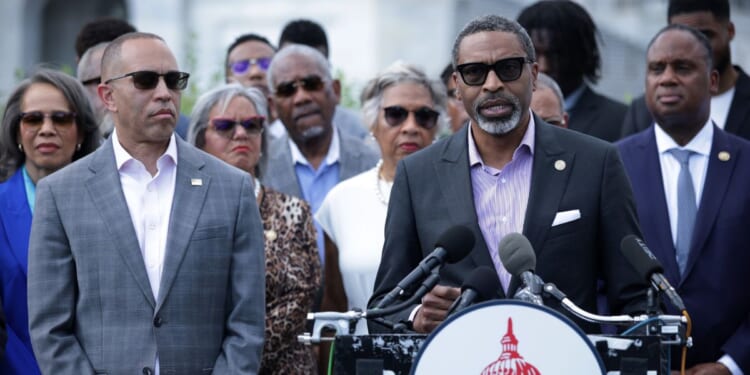 House Minority Leader Hakeem Jeffries looks on as NAACP President Derrick Johnson speaks during a news conference in opposition to the SCORE Act in front of the U.S. Capitol on May 19, 2026, in Washington, D.C.