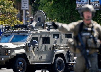 Federal authorities stand in MacArthur Park in Los Angeles.