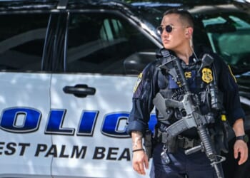 A police officer stands watch outside the Paul G. Rogers Federal Building and U.S. Courthouse during a hearing on the detention of Ryan Wesley Routh, suspected of the attempted assassination of President Donald Trump, in West Palm Beach, Florida, on Sept. 30, 2024.