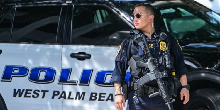 A police officer stands watch outside the Paul G. Rogers Federal Building and U.S. Courthouse during a hearing on the detention of Ryan Wesley Routh, suspected of the attempted assassination of President Donald Trump, in West Palm Beach, Florida, on Sept. 30, 2024.