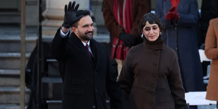 New York City Mayor Zohran Mamdani waves next to his wife Rama Duwaji during his public inauguration ceremony followed by a block party at City Hall in New York on Jan. 1, 2026.