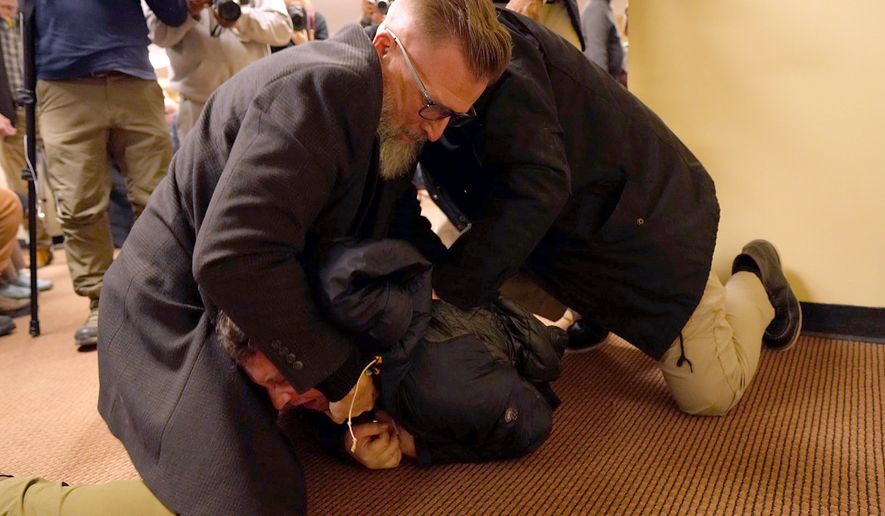 A man is tackled to the ground after spraying an unknown substance on U.S. Rep. Ilhan Omar, D-Minn., during a town hall on Jan. 27, 2026, in Minneapolis. (Richard Tsong-Taatarii/Minnesota Star Tribune via AP, File)