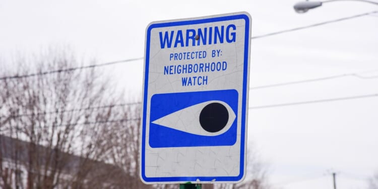 A blue and white neighborhood watch sign.