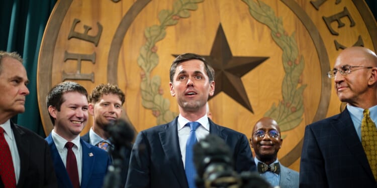 Mayes Middleton addresses the media in the Texas Capitol .