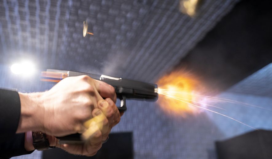 A semi-automatic pistol with a conversion device installed making it fully automatic is fired as four empty shell casings fly out of the weapon, at the Bureau of Alcohol, Tobacco, Firearms, and Explosives (ATF), National Services Center in Martinsburg, W.Va., on Thursday, March 2, 2023. (AP Photo/Alex Brandon) **FILE**