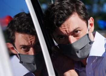 Jon Ossoff listens to a supporter at a campaign event on October 3, 2020 in Lithonia, Georgia.