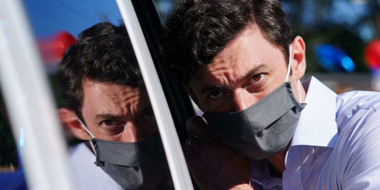 Jon Ossoff listens to a supporter at a campaign event on October 3, 2020 in Lithonia, Georgia.