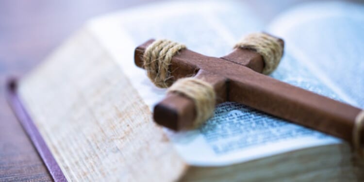 A crucifix lays on a Bible.